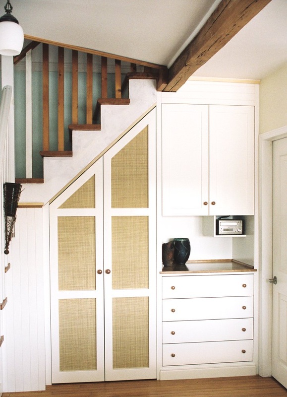 Under Stair Closet and Build in Cabinets: white paint, cherry wood top and knobs, woven cane door panels.